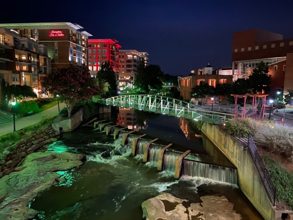 View at night of the Reedy River with West End on the Left and Greenville on right.