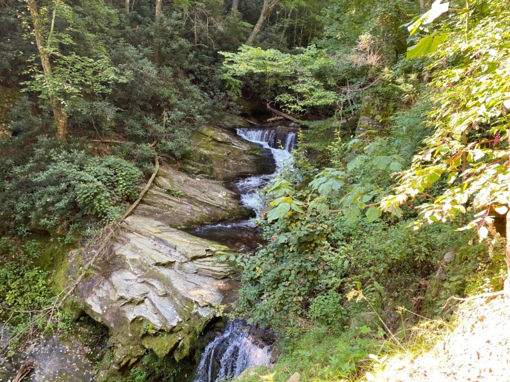 Water cascading around remains of a dam