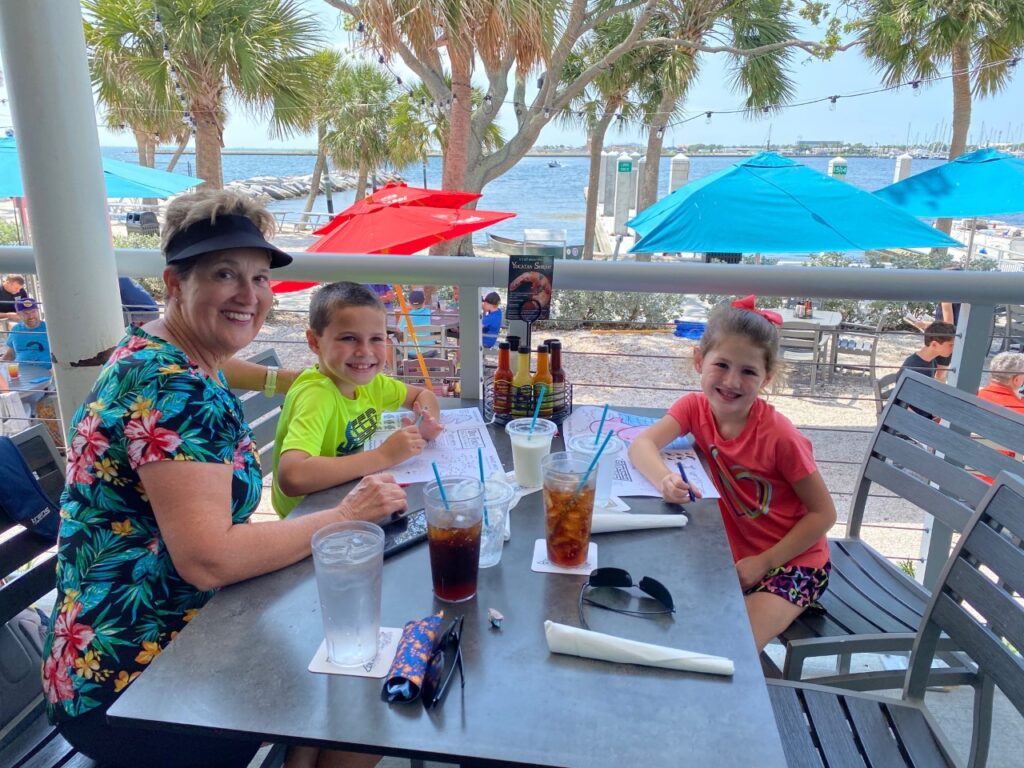 Grandma, Keaton and Kaia enjoying sitting outside at Doc Ford's for lunch.