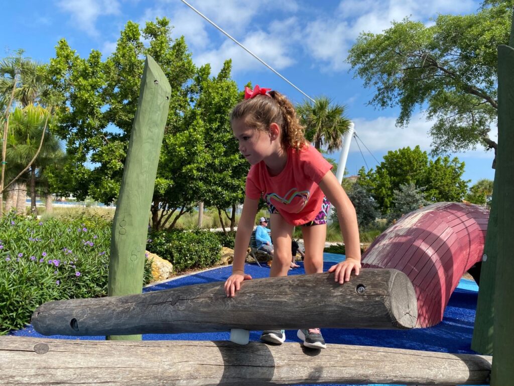 Kaia likes climbing the logs.