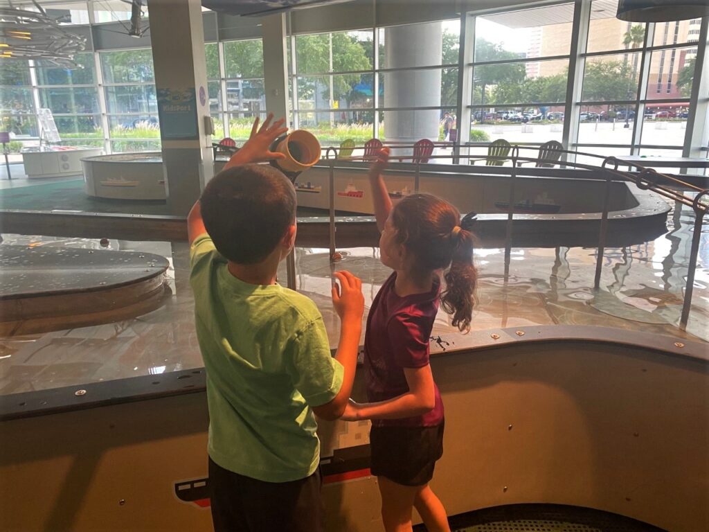 Keaton and Kaia put balls in a tube that roll over a replica of the Sunshine Skyway Bridge.