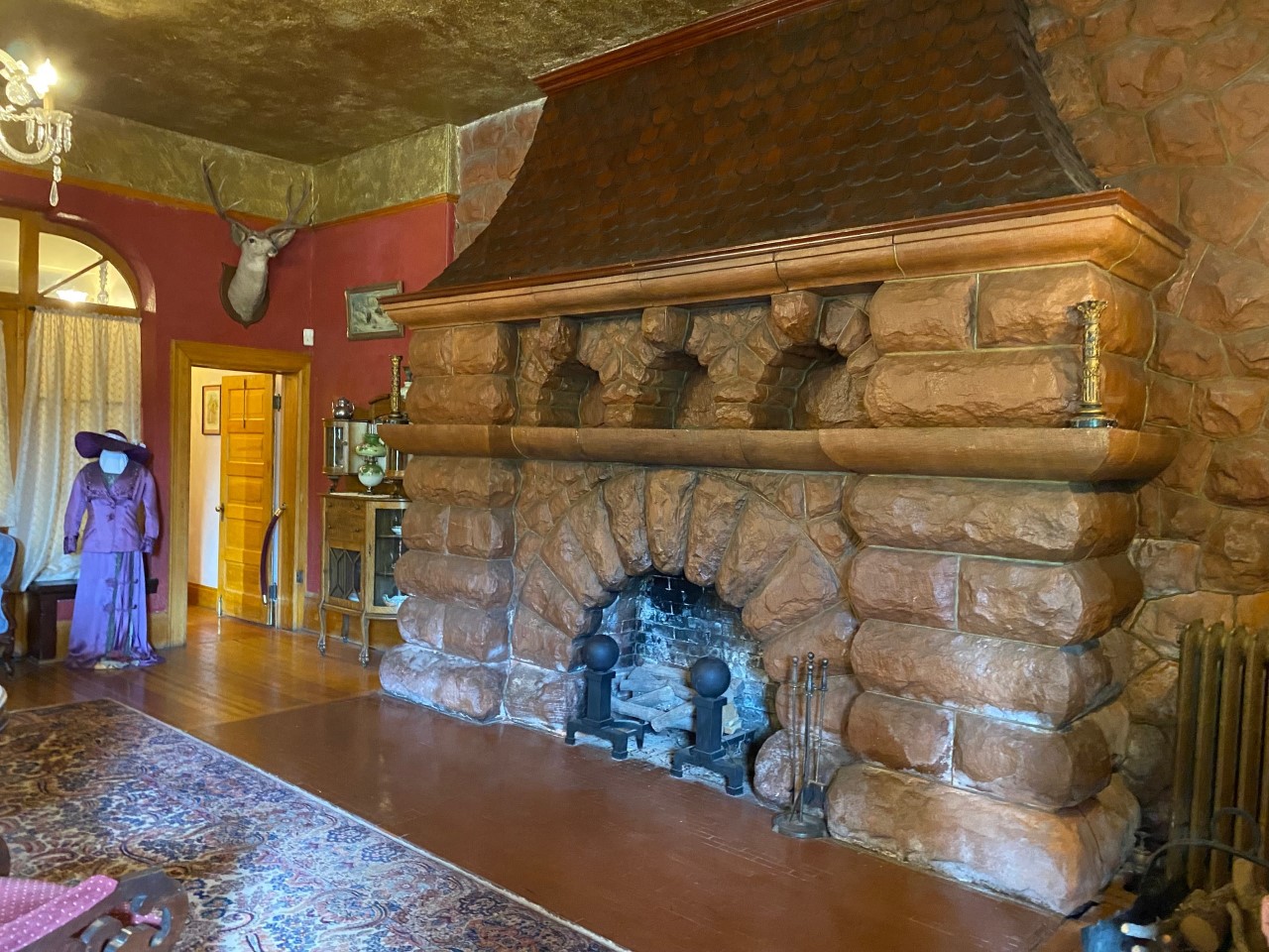 The 20-ton, red sandstone fireplace with an arched hearth