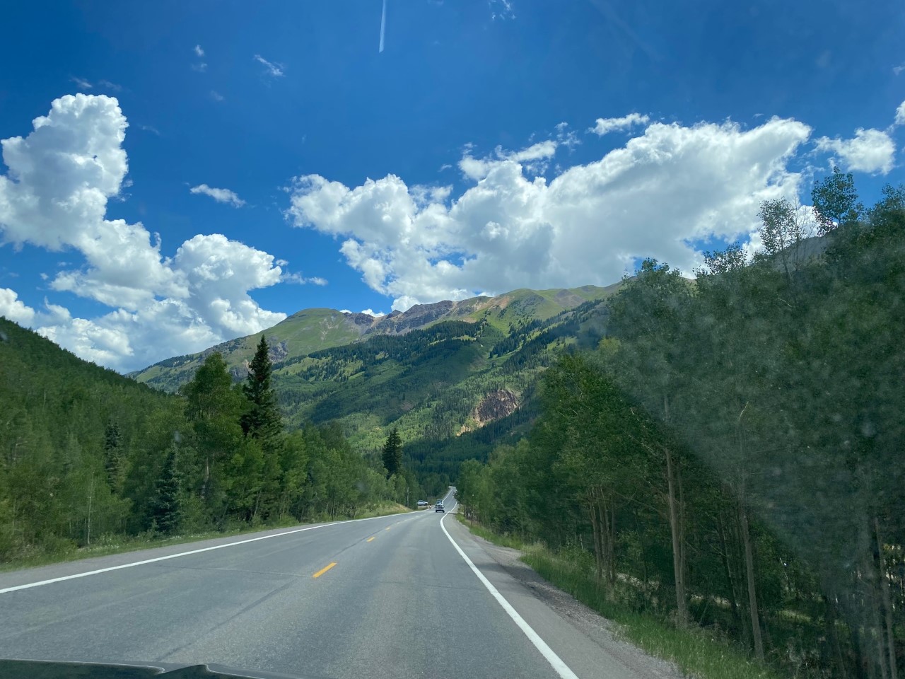The Million Dollar Highway cuts through some scenic mountains as it descends and ascends to Ouray.