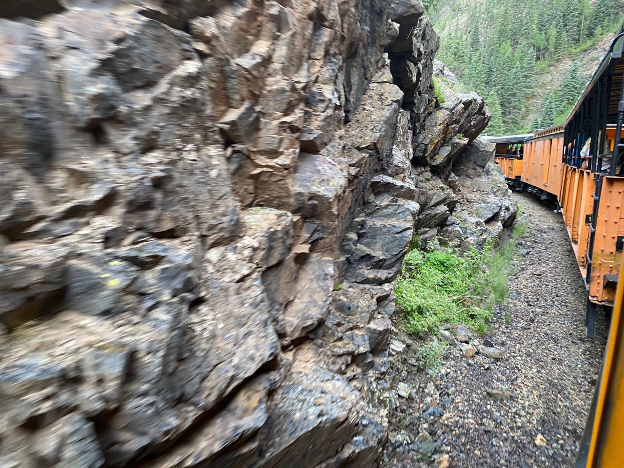 Train chugs along the edge of the mountains on the way to Silverton.