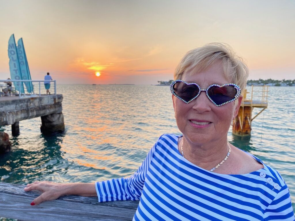 Charlene with her fun heart sunglasses at sunset.