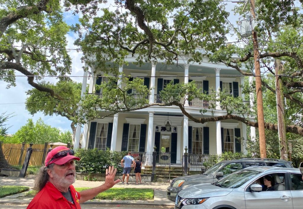 Colin points out specific architecture and history of homes on the Garden District Tour.