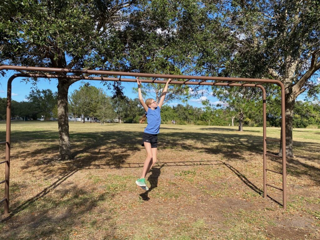 Lucy has great form on the Horizontal Bars.