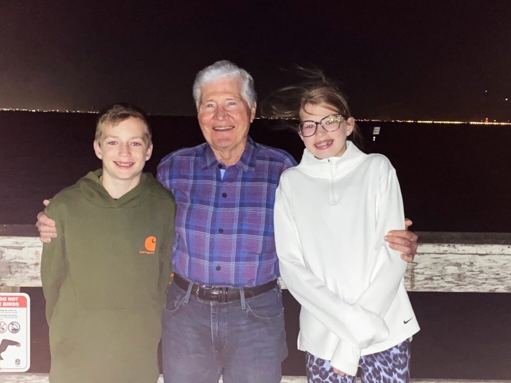 Louis, Papa and Lucy at Safety Harbor Pier. Lights of Tampa in background.