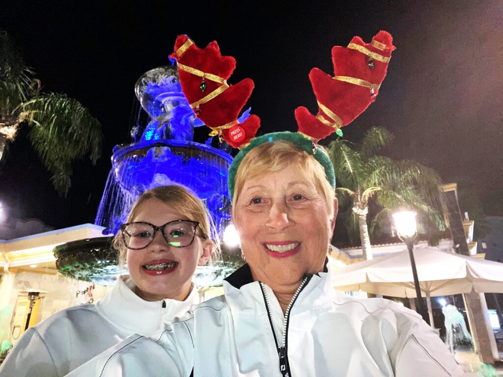 Mimi and Lucy outside the Safety Harbor Resort. The fountain is blue behind Lucy's head.