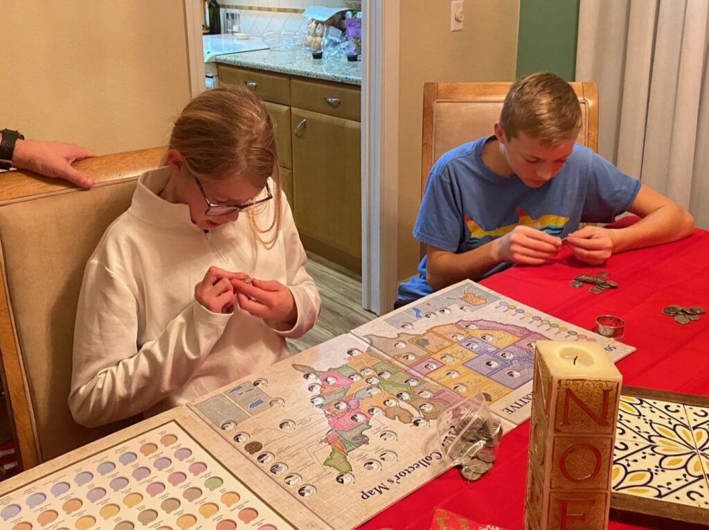 Lucy & Louis carefully check each coin to see if it matches a space on the USA Coin Map.