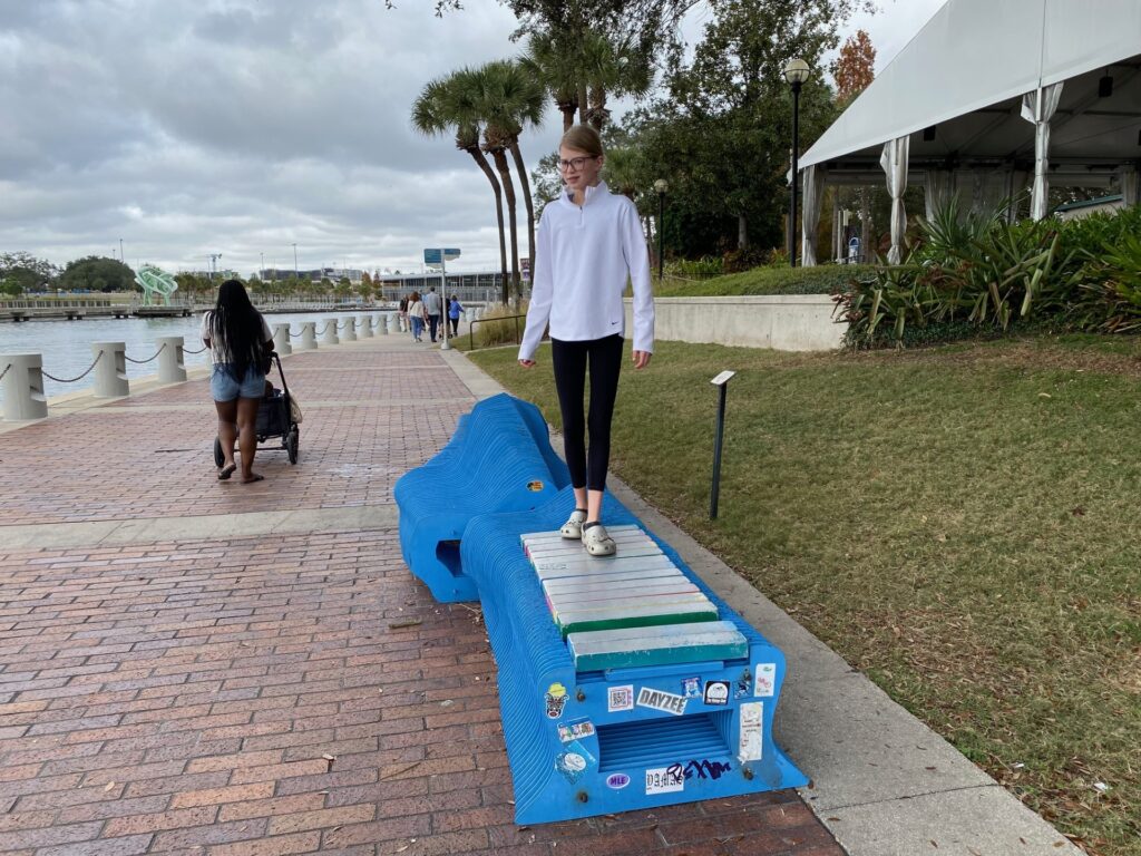 Lucy walks along the xylophone on Tampa Riverwalk.