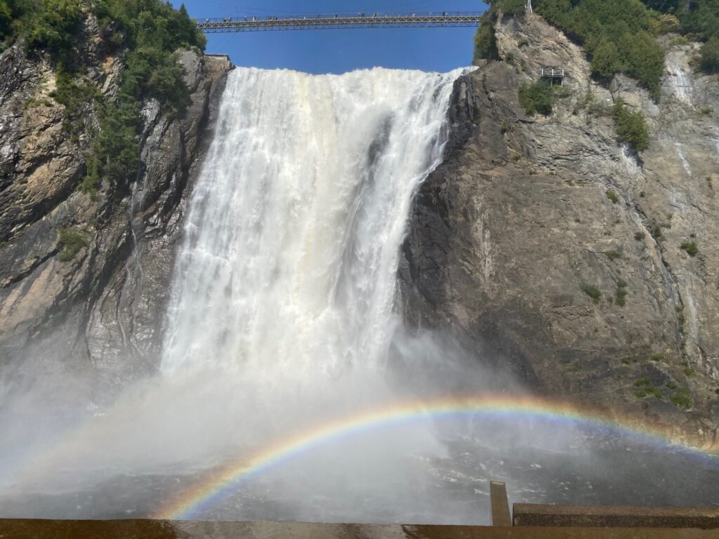 View of base of Montmorency Falls at the Promontory with a rainbow.